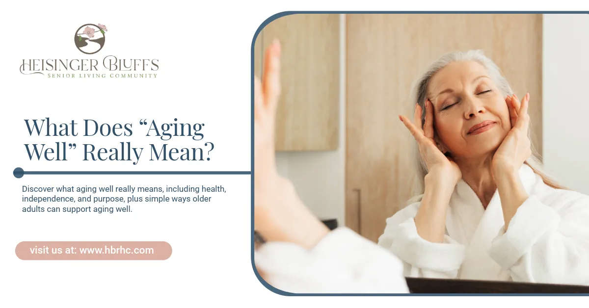 An elderly woman in a white robe is touching her face in front of a mirror,