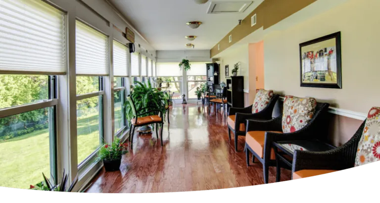 A long hallway with  windows and chairs