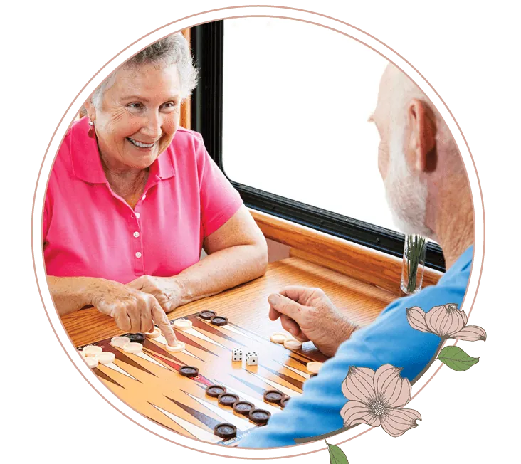 A man and a woman playing a game of backgammon