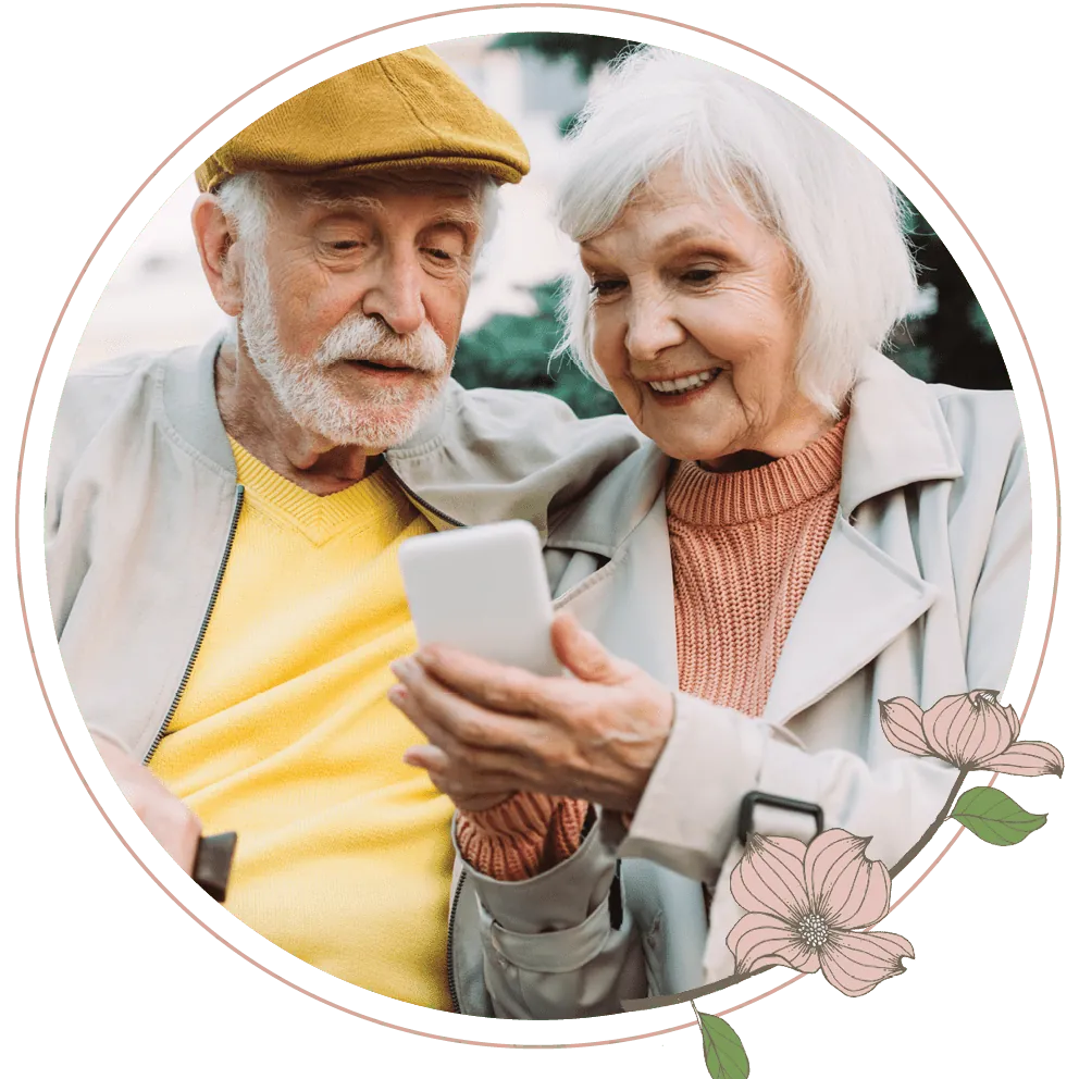 An elderly couple looking at a cellphone together