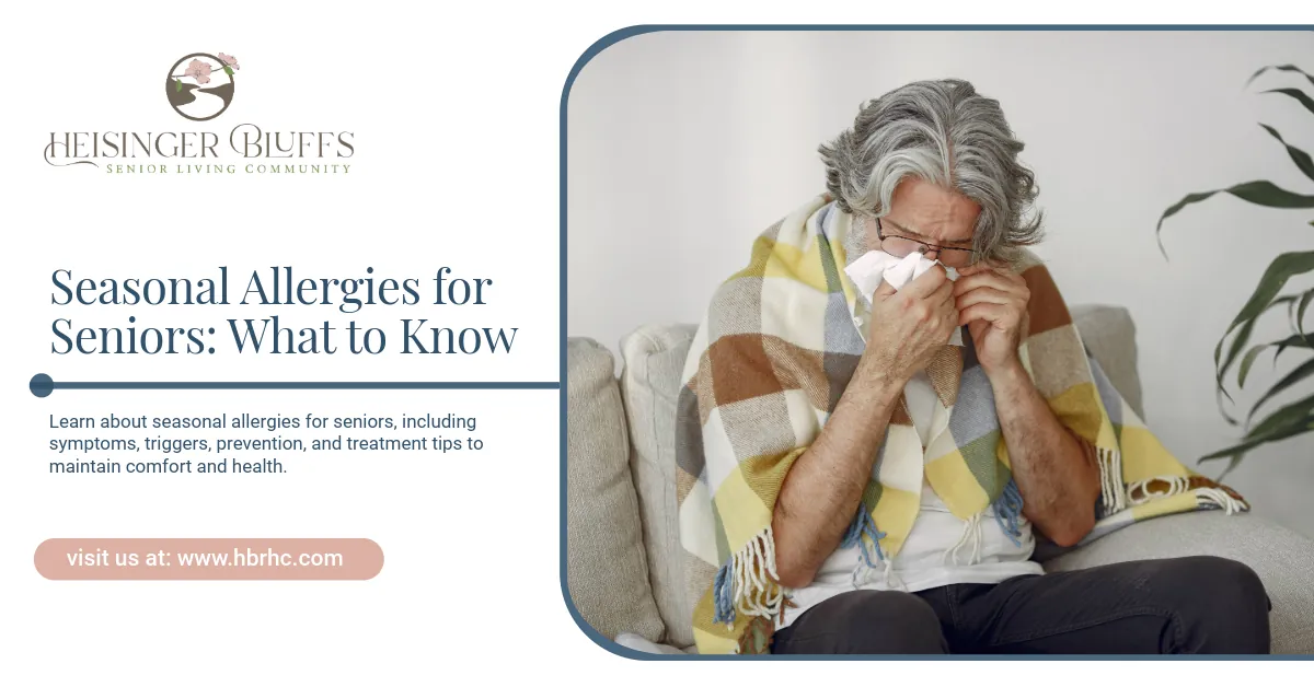 An elderly man is blowing his nose, wrapped in a blanket.