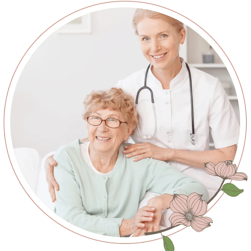 A nurse sitting next to an elderly woman on a couch
