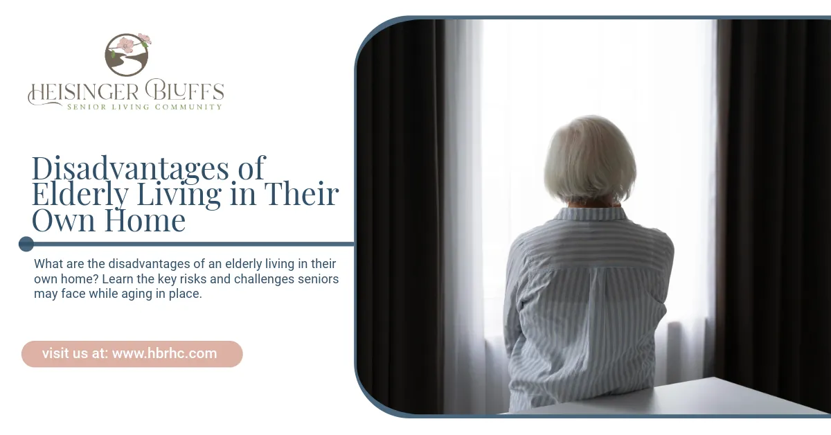 An elderly woman is sitting at a table looking out a window.