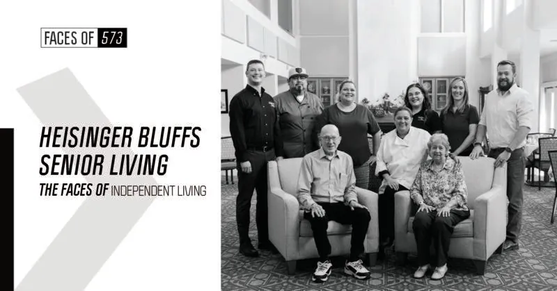 A group of people posing for a picture in a living room